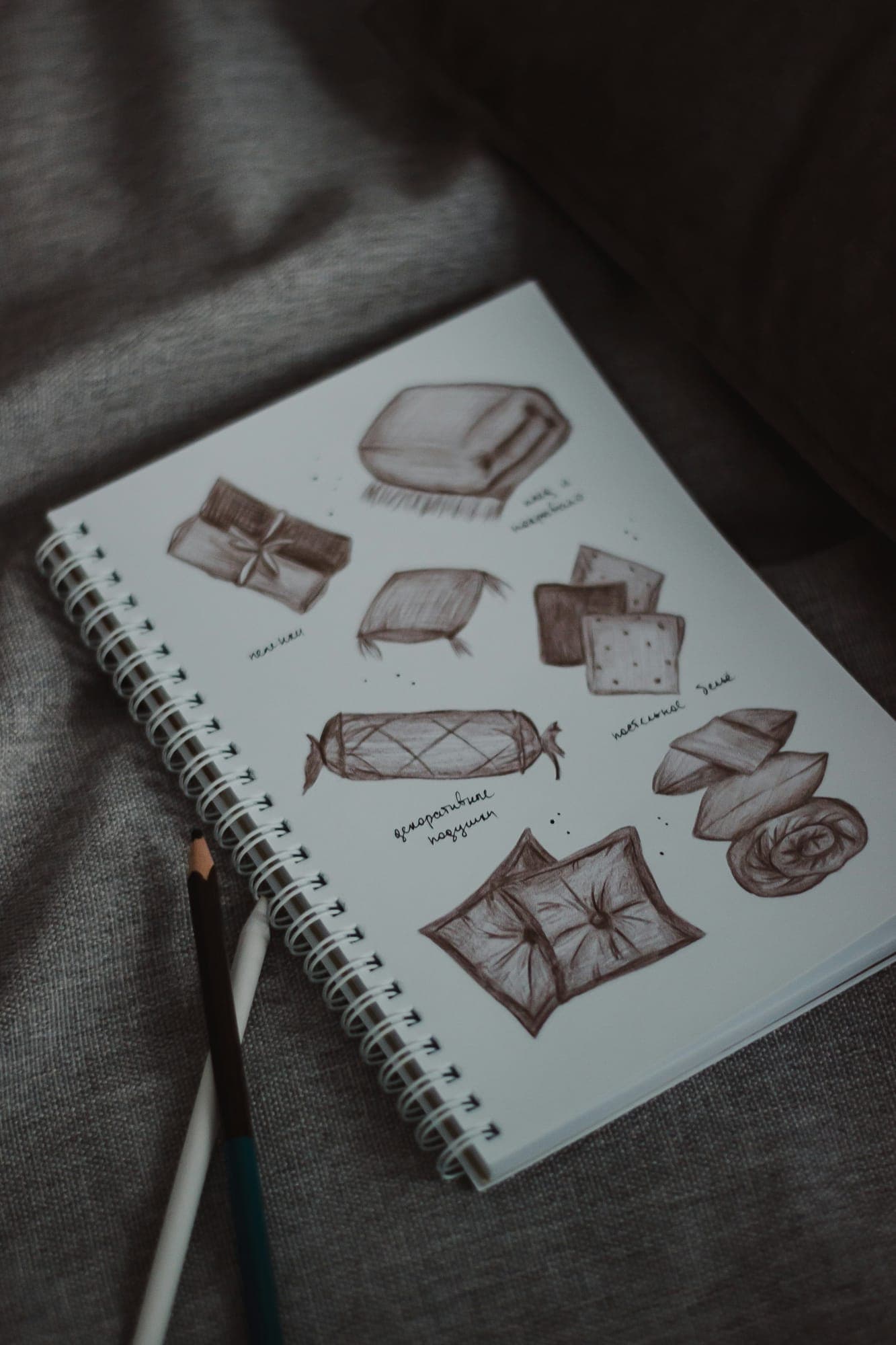 Pencil sketches of shapes in a notebook