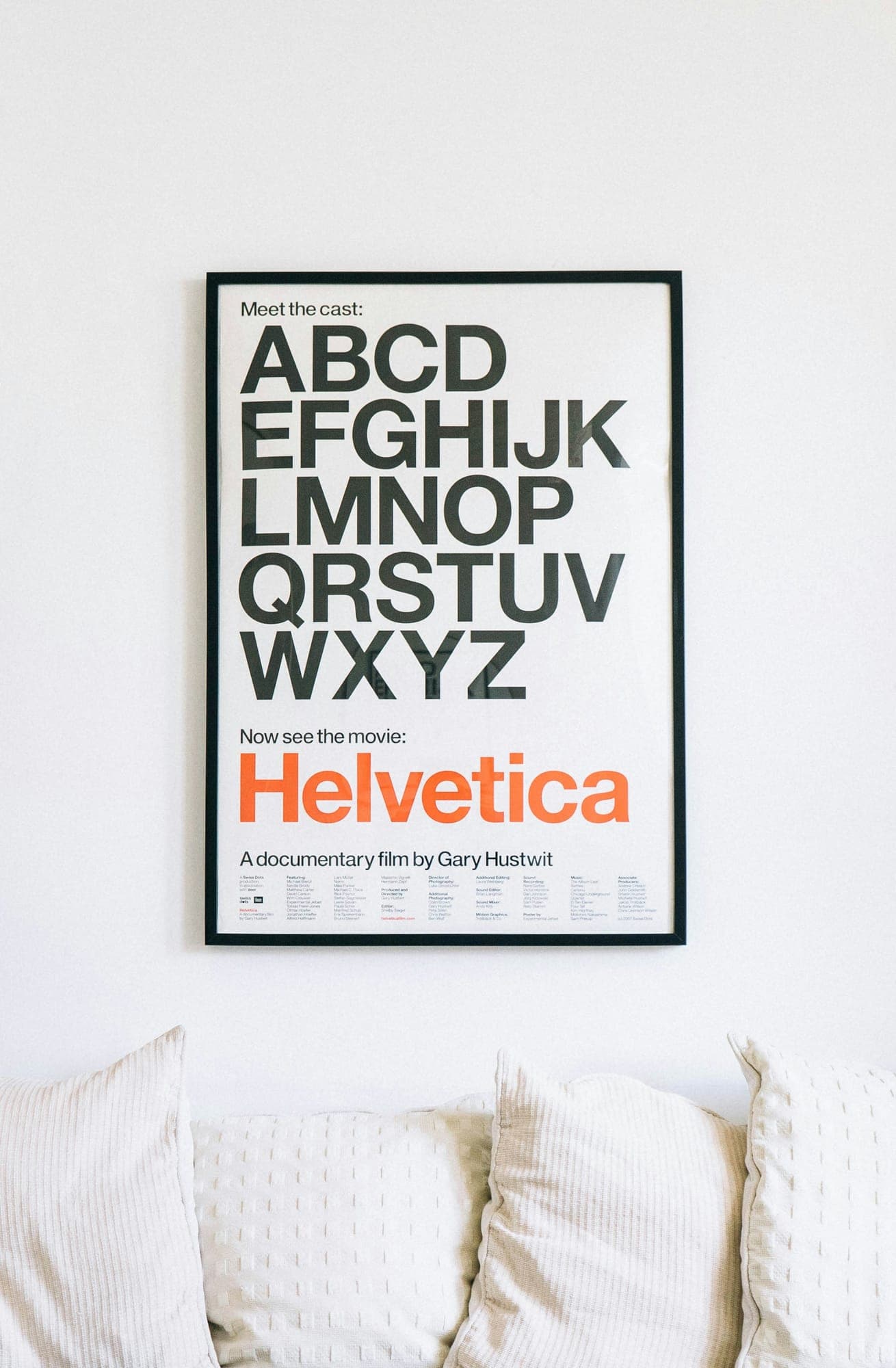 A Helvetica alphabet poster on a wall